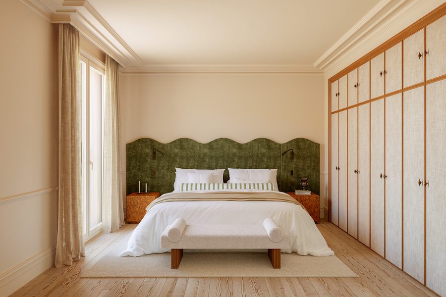 Dormitorio de la tipología C con cabecero tapizado y luz natural