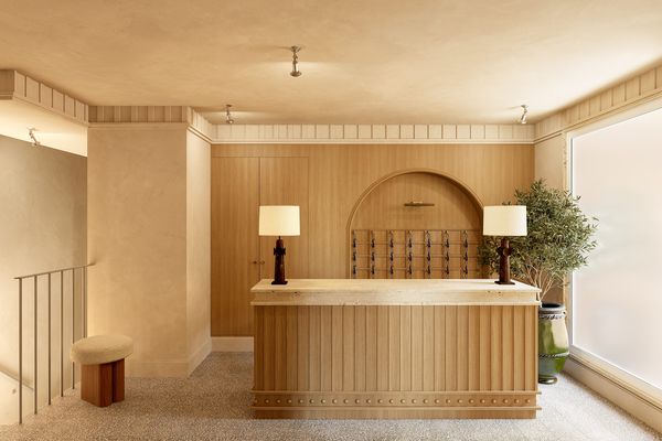 Recepción y conserjería de Casa Ayala con mostrador de madera y lámparas