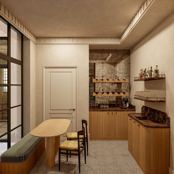 Sala multiusos con mesa de trabajo, banco tapizado y arco de piedra